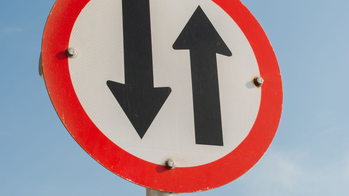 A two-way sign representing the choice between staying on a platform and going direct