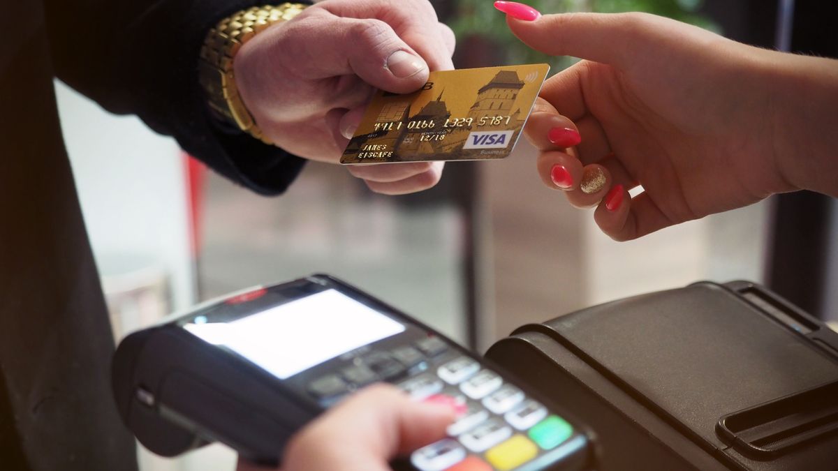 A card payment being processed on a terminal — taking payment at the time of booking